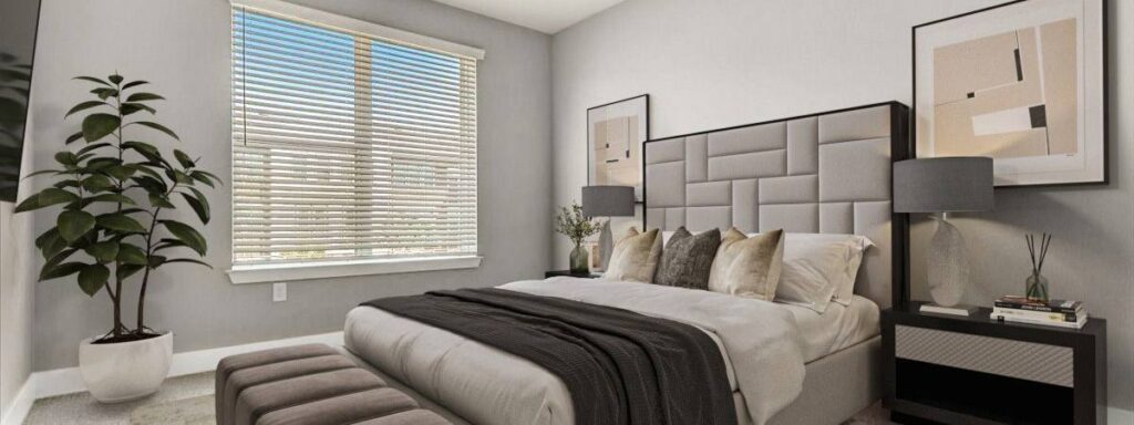 Modern bedroom with a large bed, upholstered headboard, bedside tables with lamps, abstract wall art, a potted plant, and a window with blinds letting in natural light.